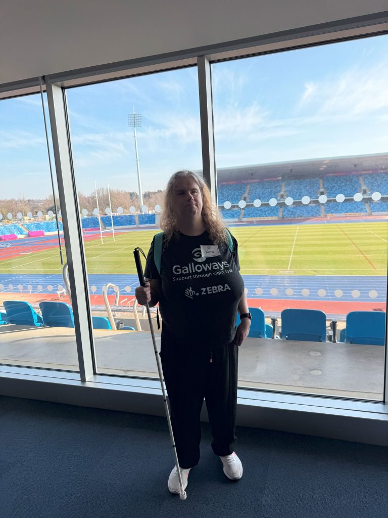 Kara stood overlooking the athletics track at the commonwealth games stadium in Birmingham during the 2025 spring national championships.