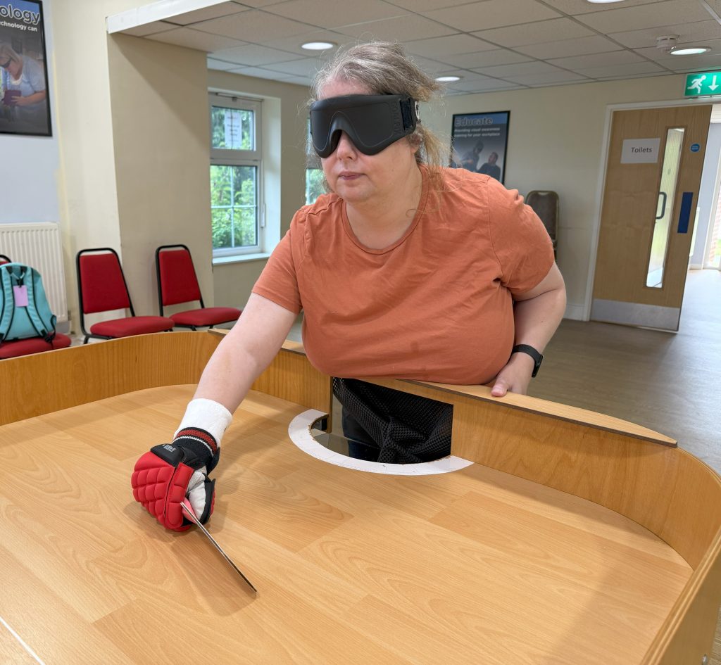 Kara at the end of the showdown table having just struck the ball towards her opponent.