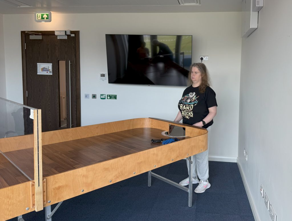 Kara during the UK nationals waiting for the referee to inspect her playing equipment which is laid out on the table ready.