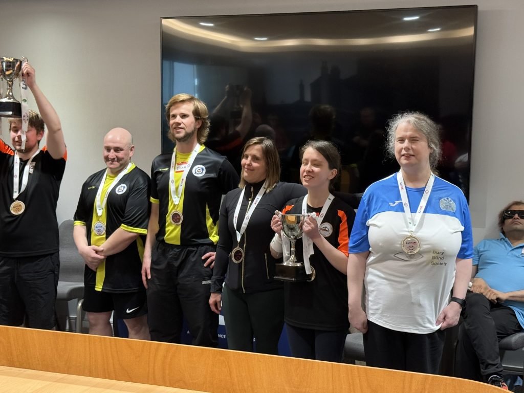 All the medallists from this years Showdown nationals competition stood together behind a showdown table proudly wearing their medals.